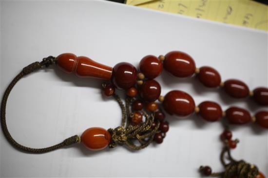 A Persian gilt metal and graduated amber bead tassel drop necklace, 180cm incl. tassel.